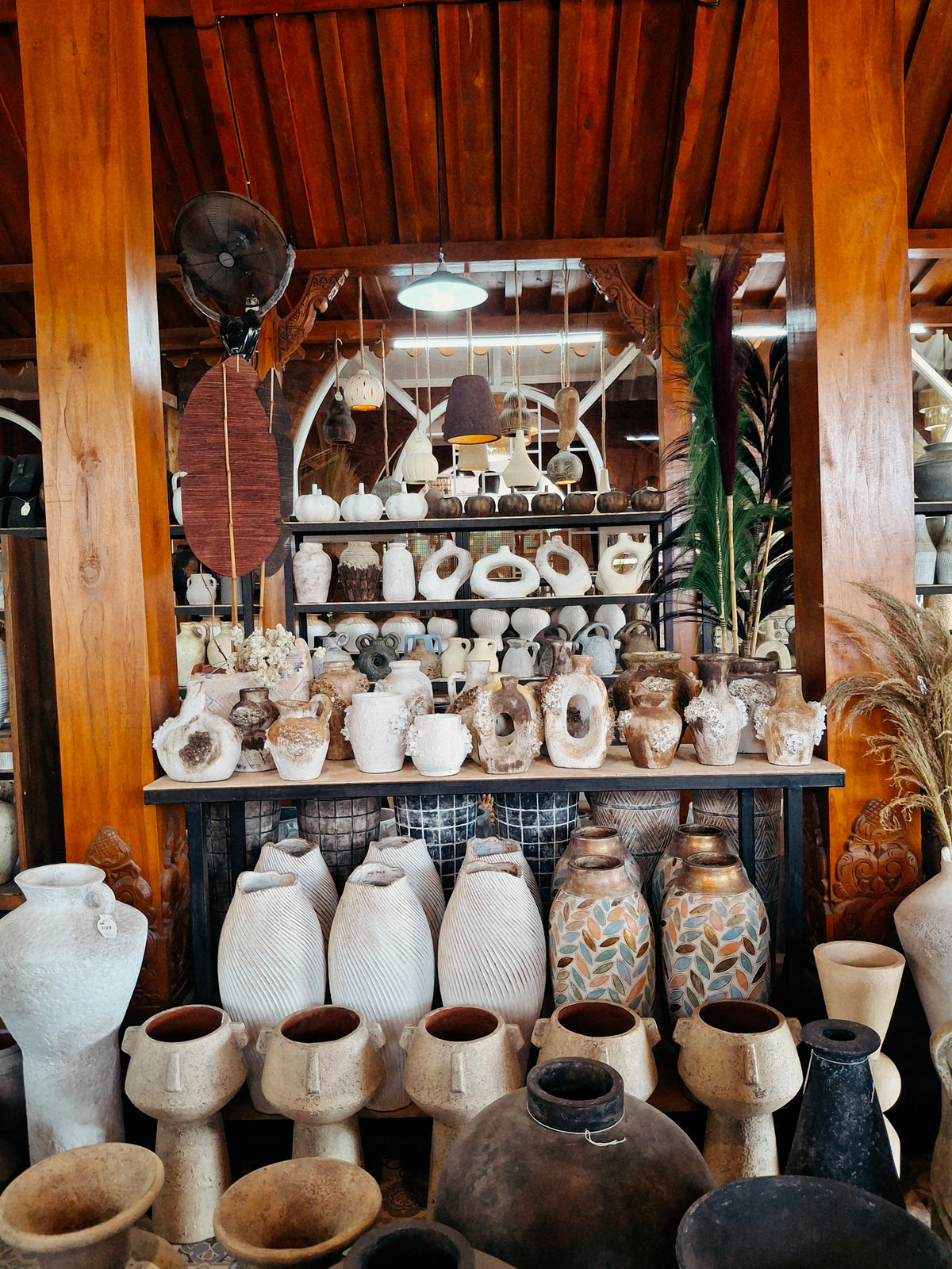 Terracotta vases and pots displayed under the joglo roof